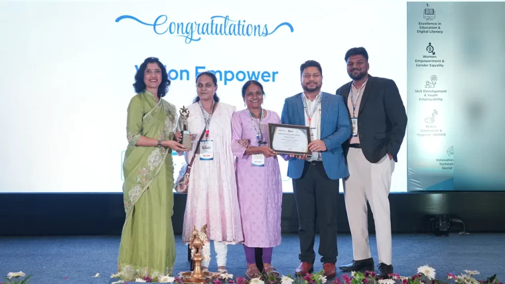 Vision Empower team with the Award of Excellence (Gold) on the stage