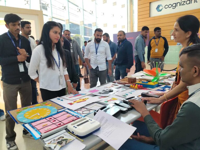 Vision Empower team members engage with visitors during Cognizant Foundation’s 20th Anniversary celebration, showcasing accessible learning devices, tactile STEM materials, and inclusive science activity models designed for students with visual impairment.