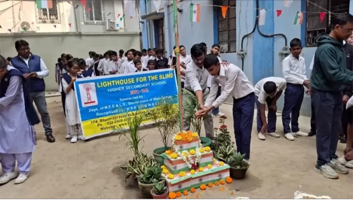 Students are engaged in a hands-on activity around a decorated setup, likely part of a school celebration or awareness event.
The scene shows students actively participating under guidance, fostering experiential learning.
The activity encourages engagement through touch and collaboration.