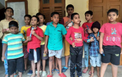 This image is of students of BBA, standing for a picture posing with chocolates in their hand, distributed by VE on the occasion of Children’s Day celebrations