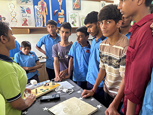 photograph of children standing around a table in an accessible science lab